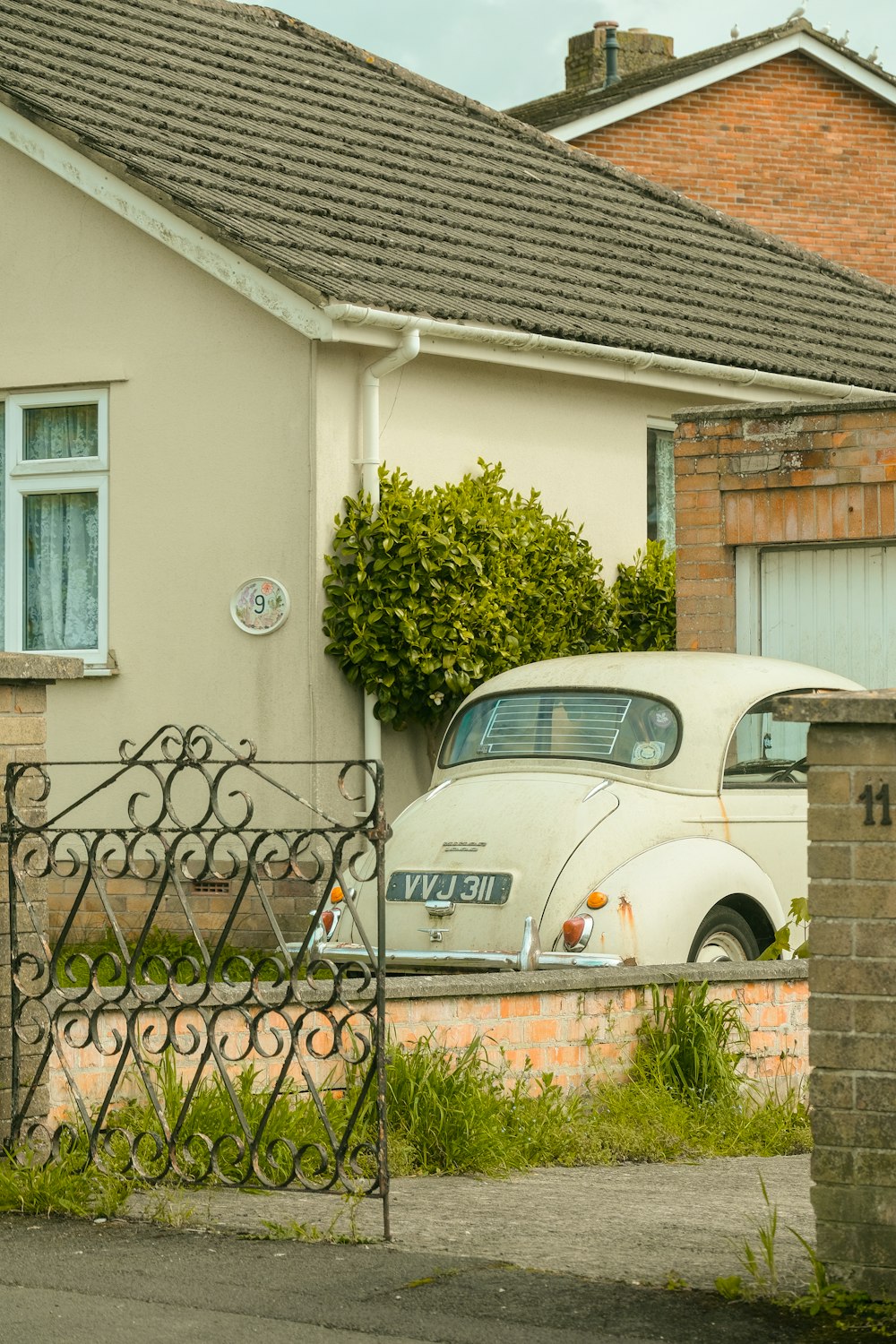 a white car parked in front of a house