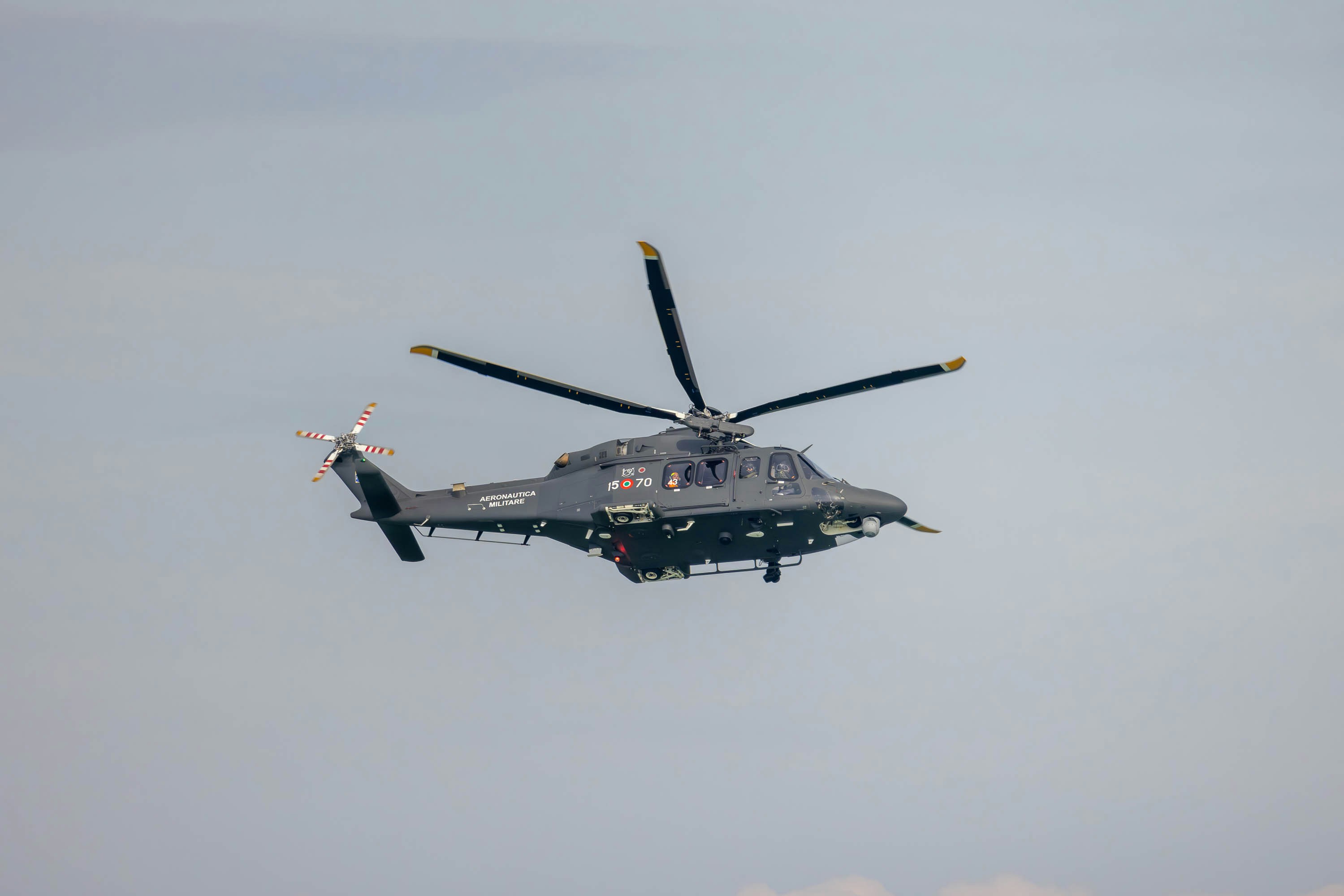 a helicopter flying in the sky with four propellers, AgustaWestland AW139 helicopter of the Italian Air Force during an air show in which it displayed the machine