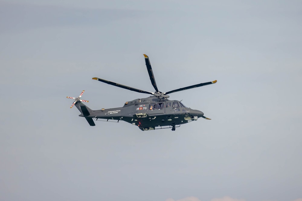a helicopter flying in the sky with four propellers
