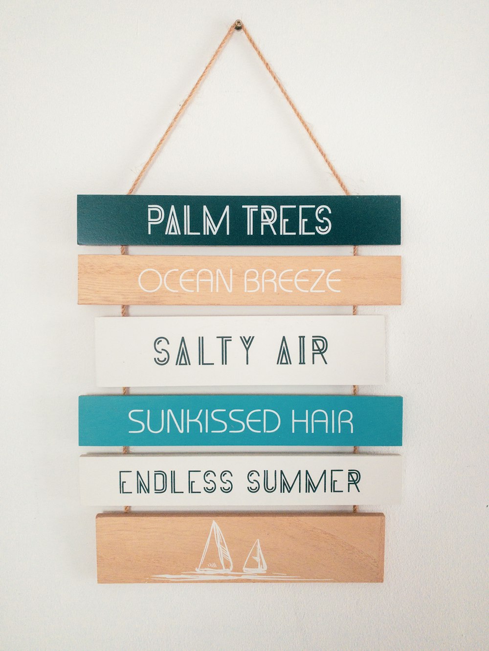 a sign hanging on a wall that says palm trees ocean breeze salty air sunkes