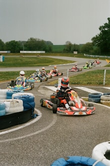 a group of people riding go karts on a track