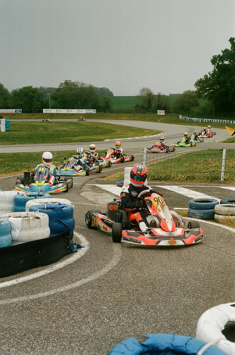 a group of people riding go karts on a track