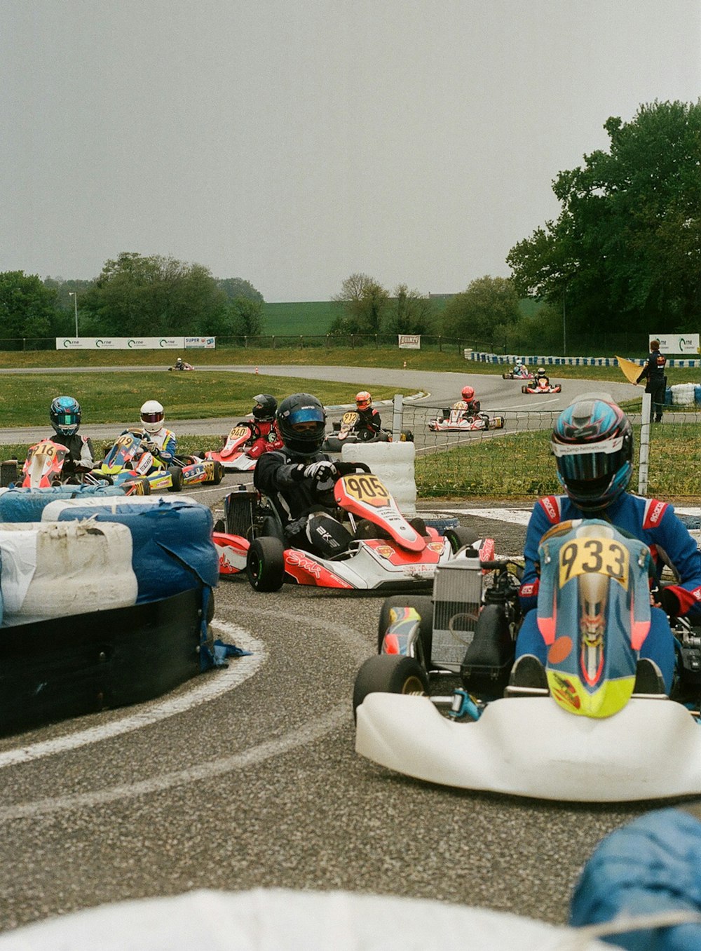a group of people riding go karts on a track