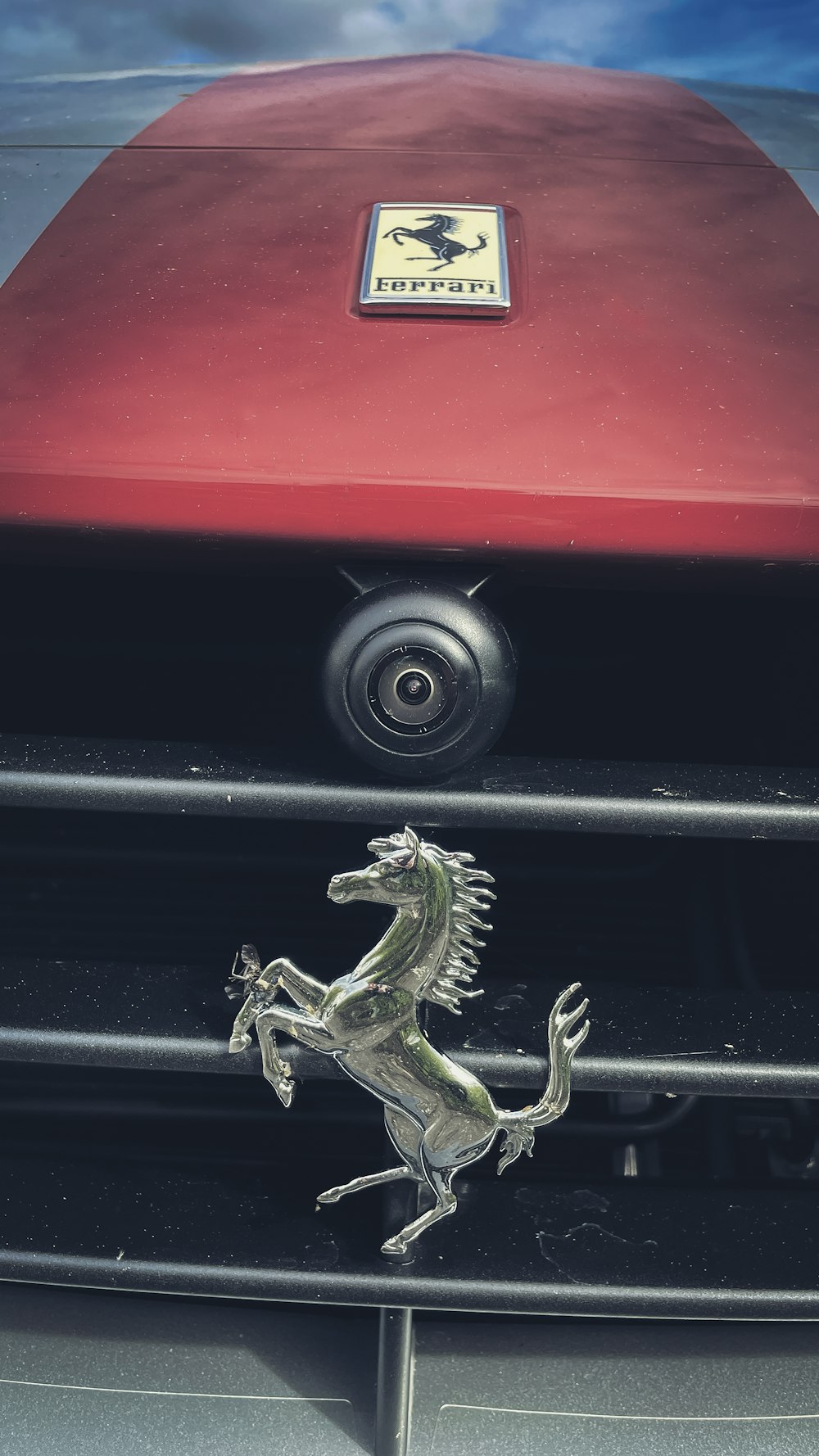 a close up of a car's grille with a horse on it