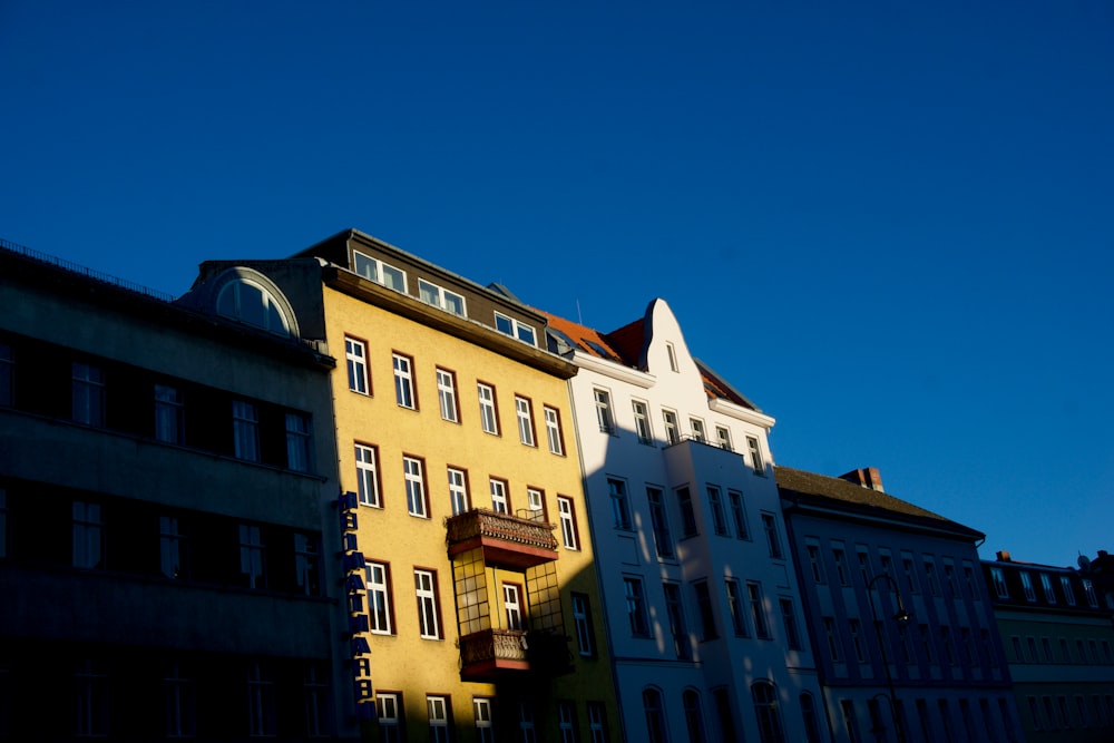 a row of buildings with a blue sky in the background