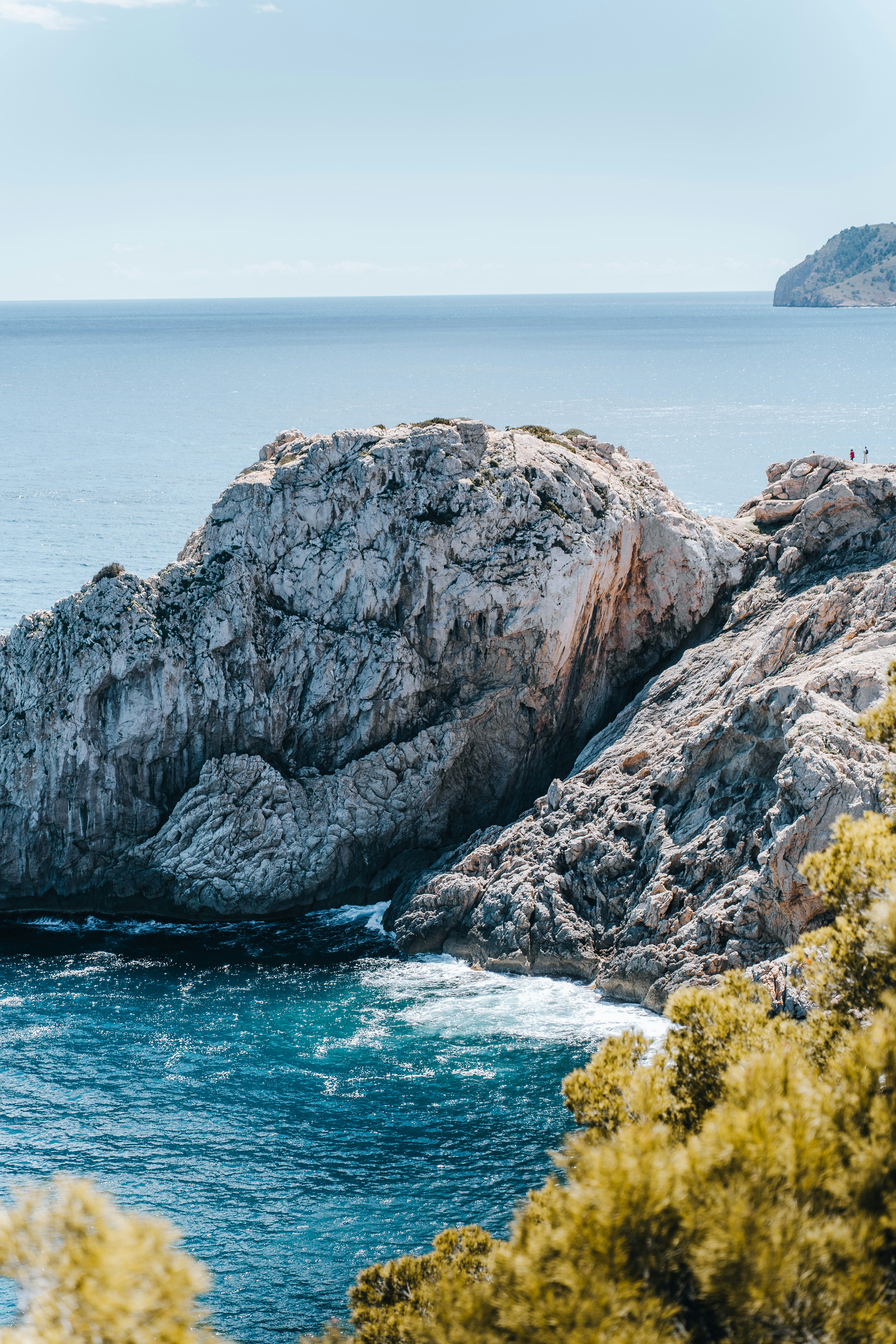 a rock outcropping in the middle of a body of water