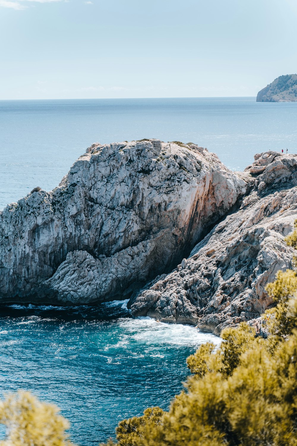 a rock outcropping in the middle of a body of water