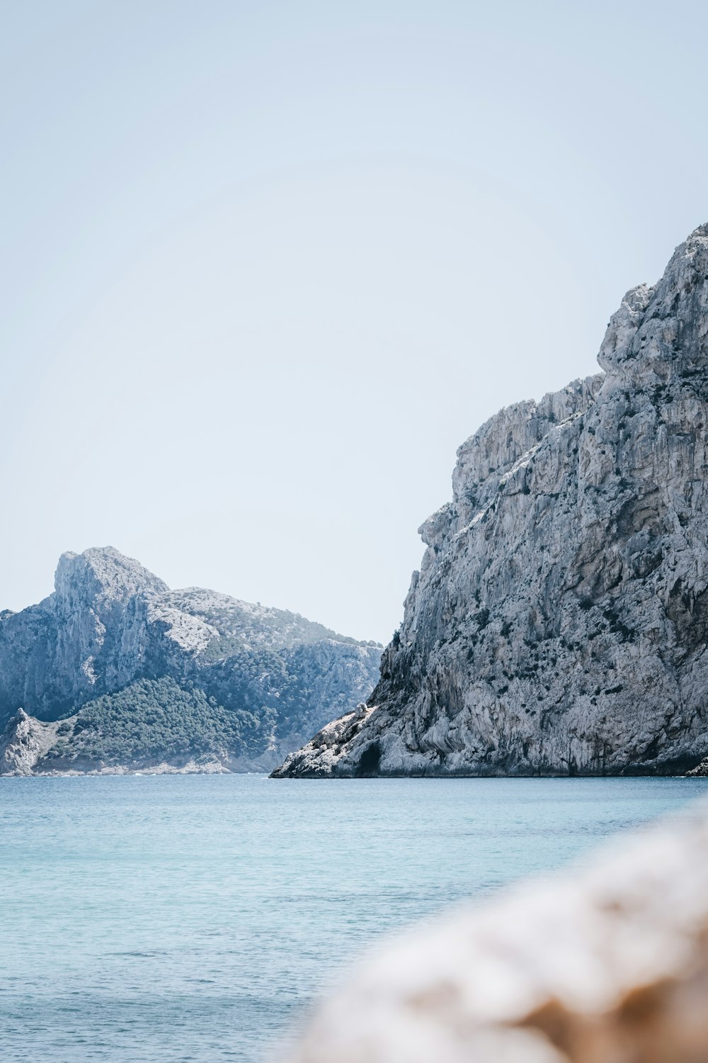 a rock outcropping in the middle of a body of water