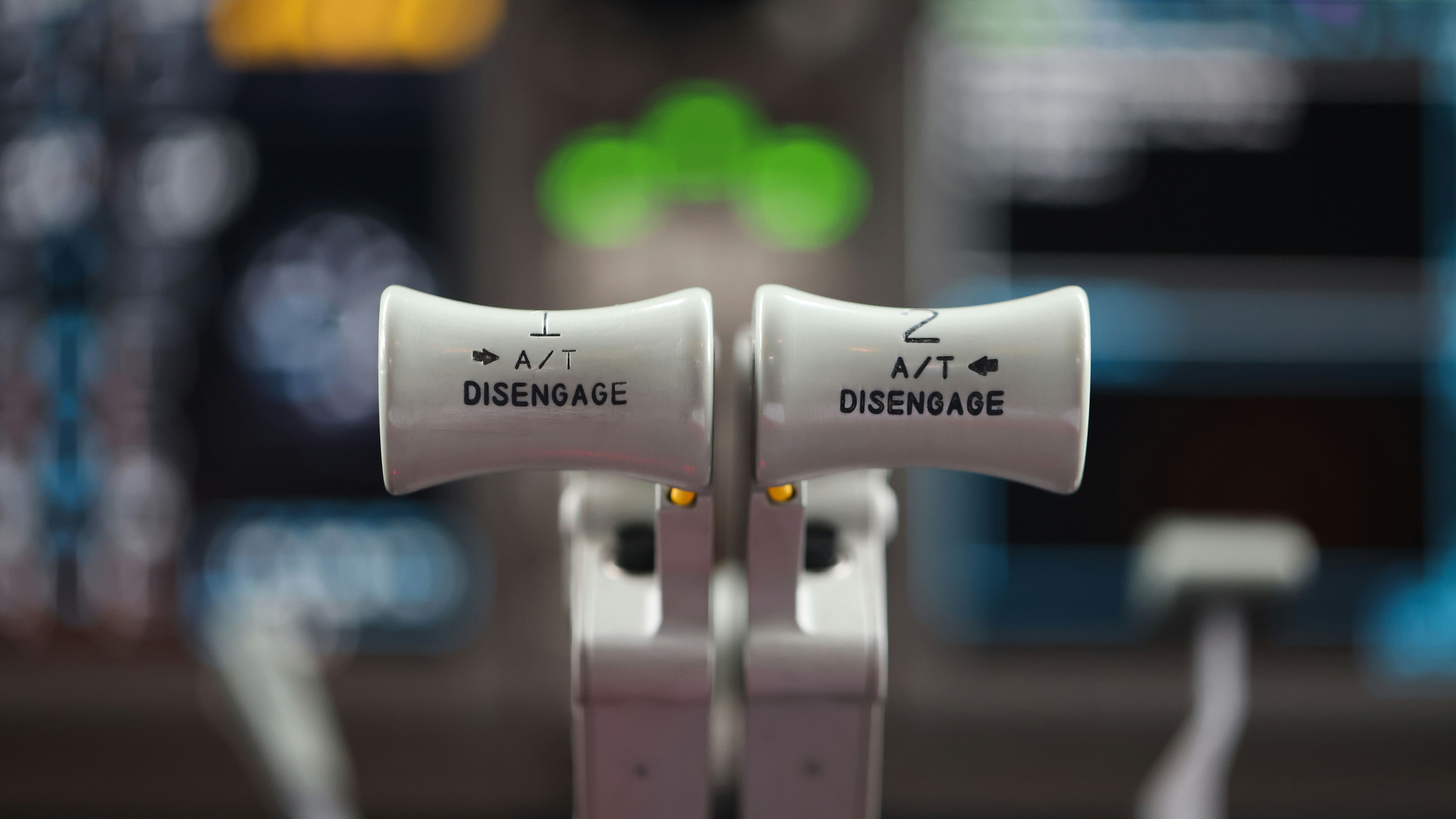 a close up of a pair of white ear buds, Close up of an Aircraft Thrust Lever