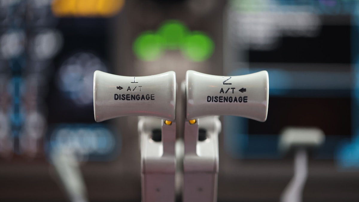 A close up of a pair of white ear buds