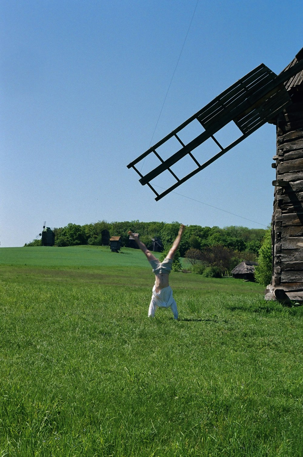 a person in a field flying a kite