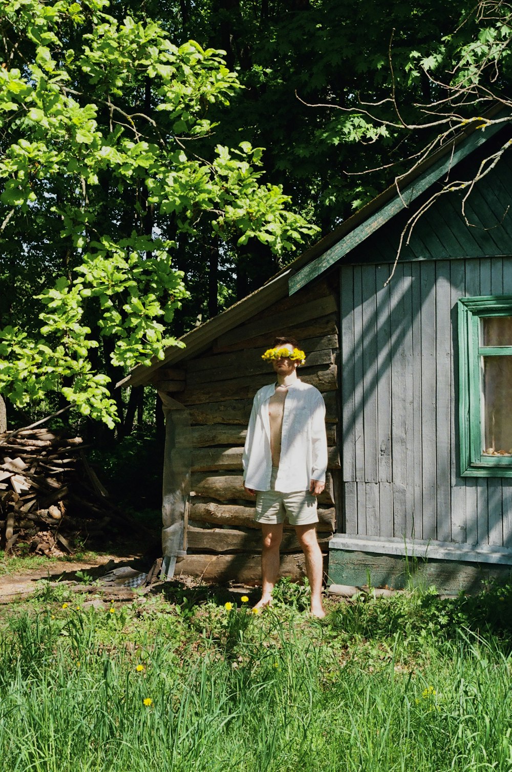 a man standing in front of a small cabin