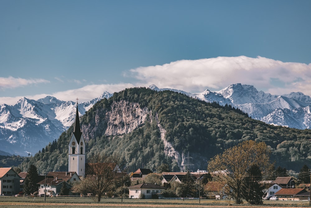 a small town with a mountain in the background