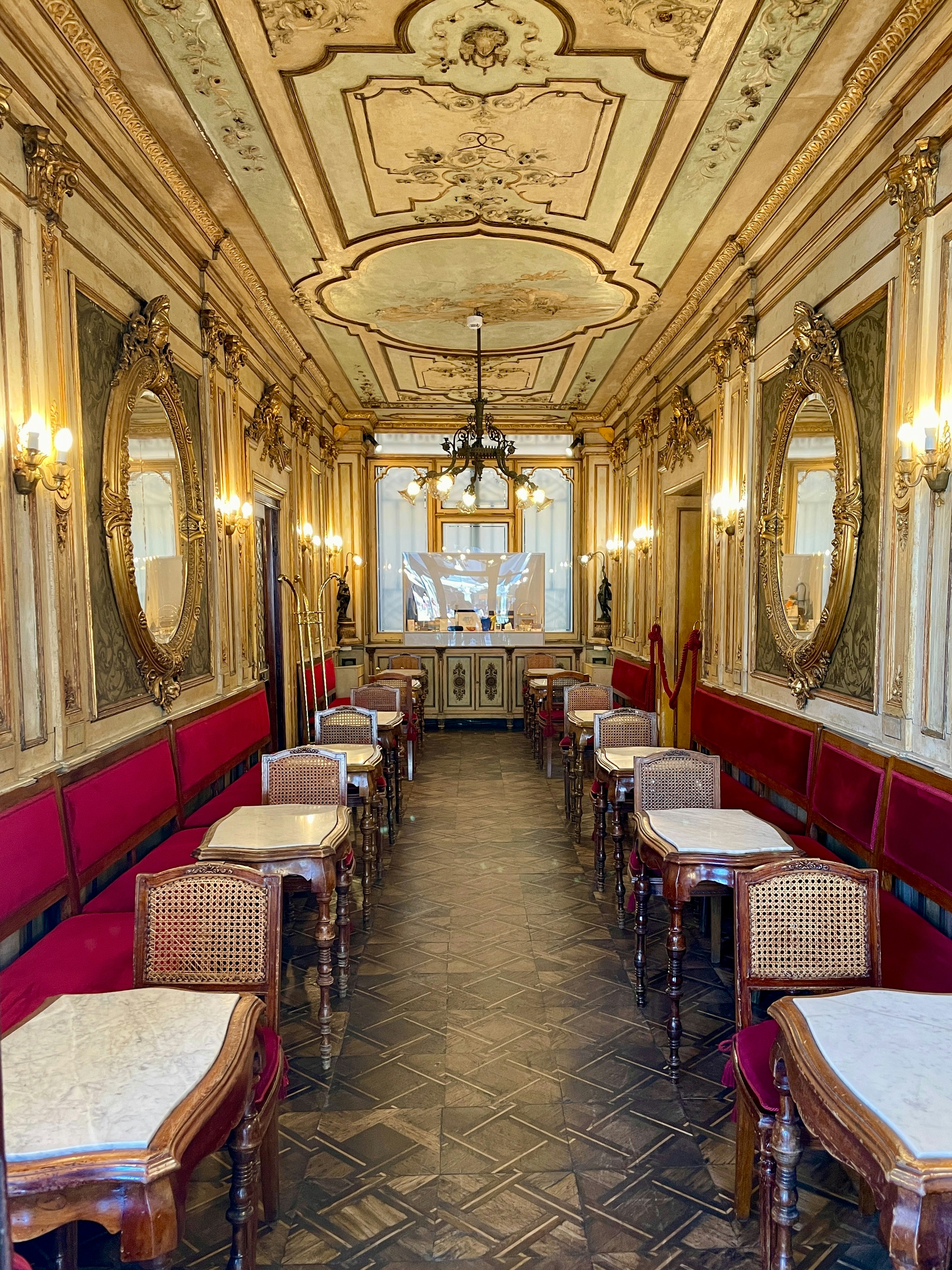 Elegant cafe interior with botanical elements, warm lighting and marble tabletops