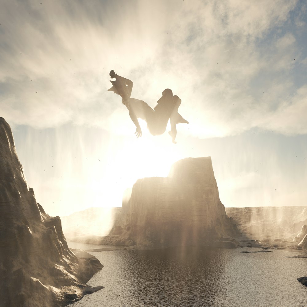 two people jumping off a cliff into a lake