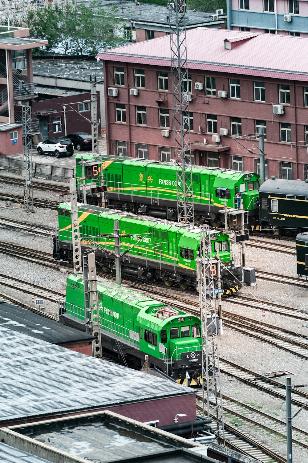 a train yard with several trains on the tracks