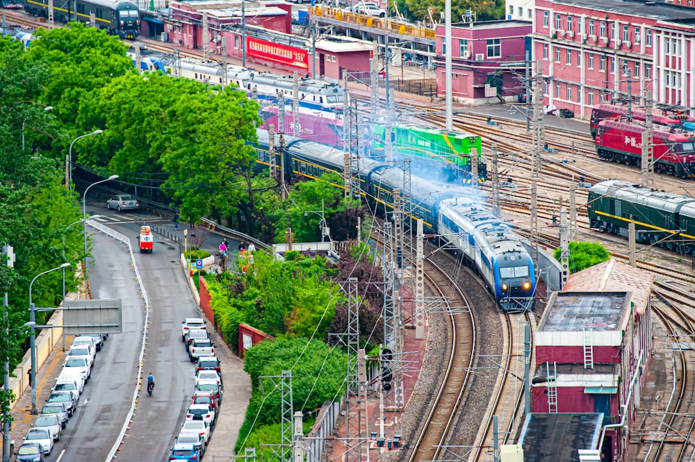 a train traveling down train tracks next to a lush green forest