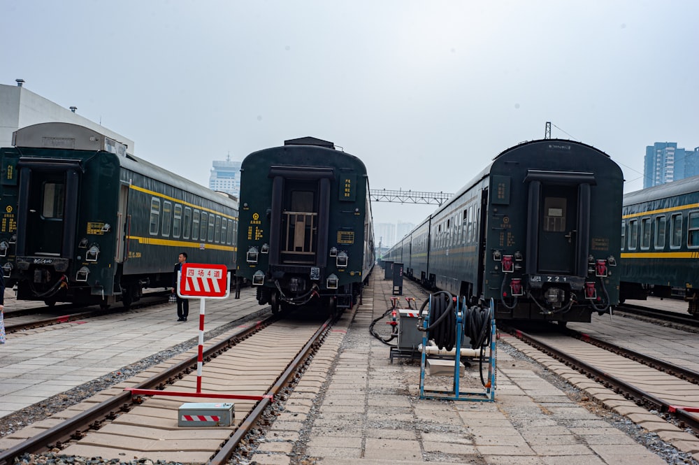 a couple of trains parked next to each other on train tracks