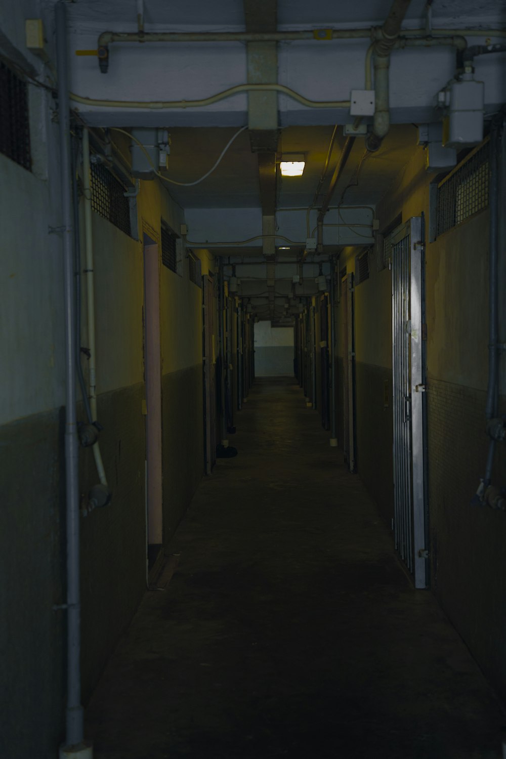 a long hallway with several doors leading to another room
