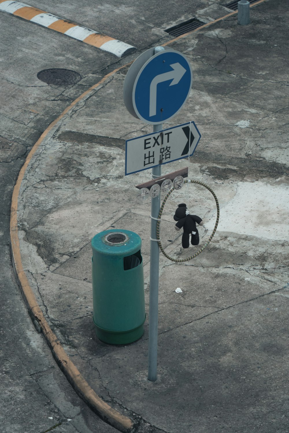 a street sign with a teddy bear attached to it