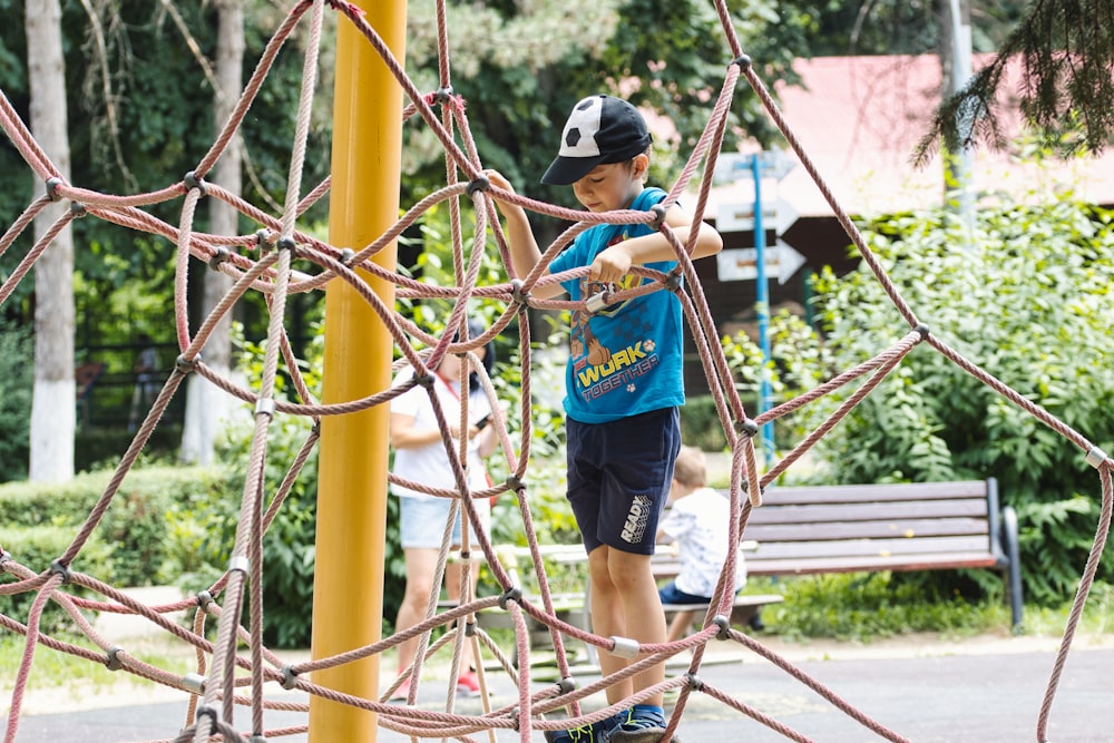 a young boy is playing on a playground