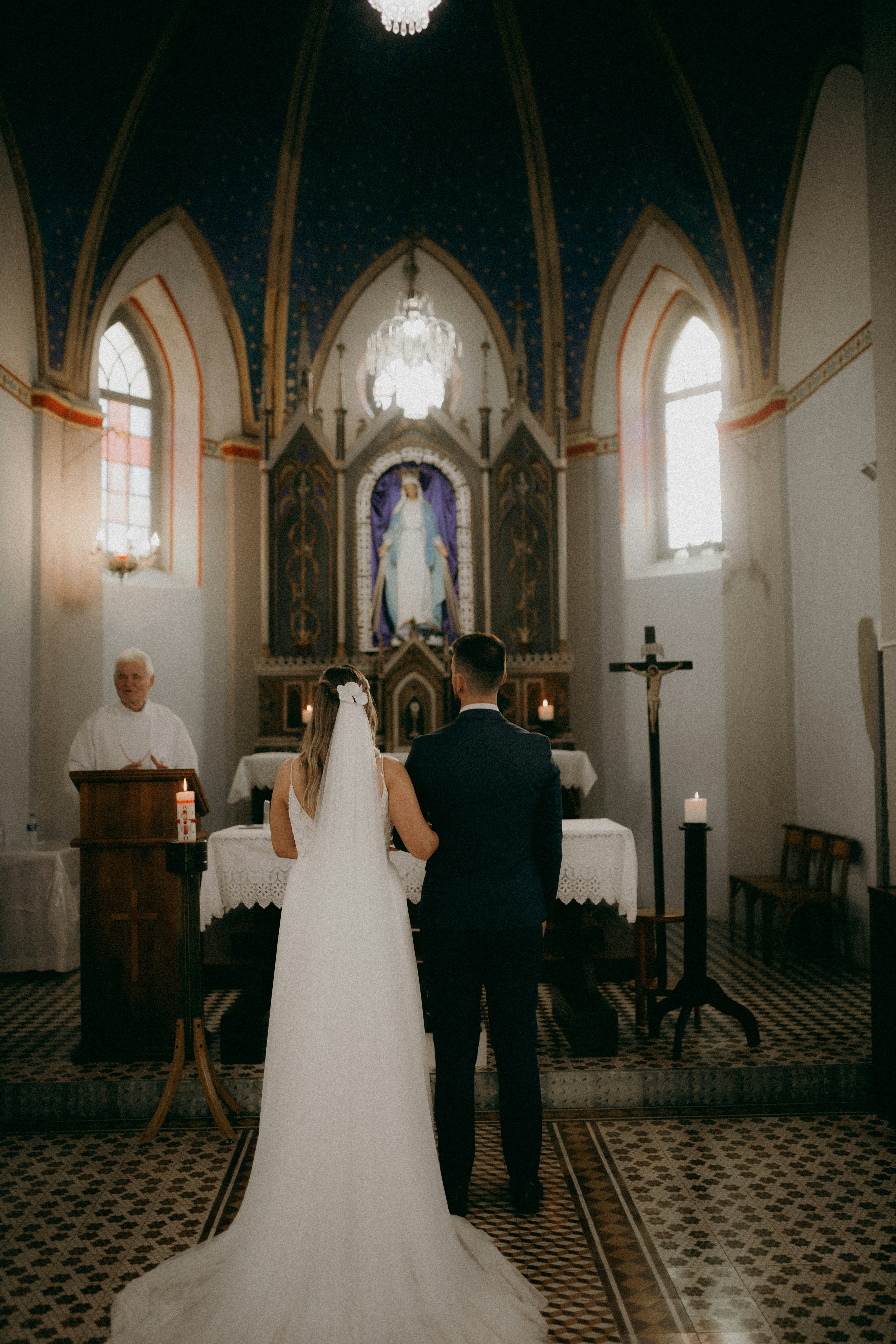a bride and groom walking down the aisle of a church