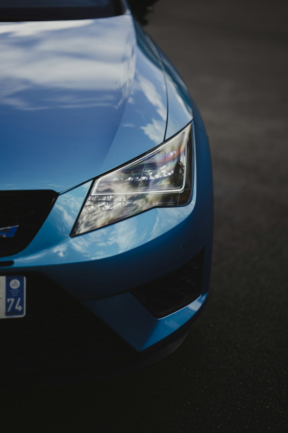 a close up of the front of a blue car