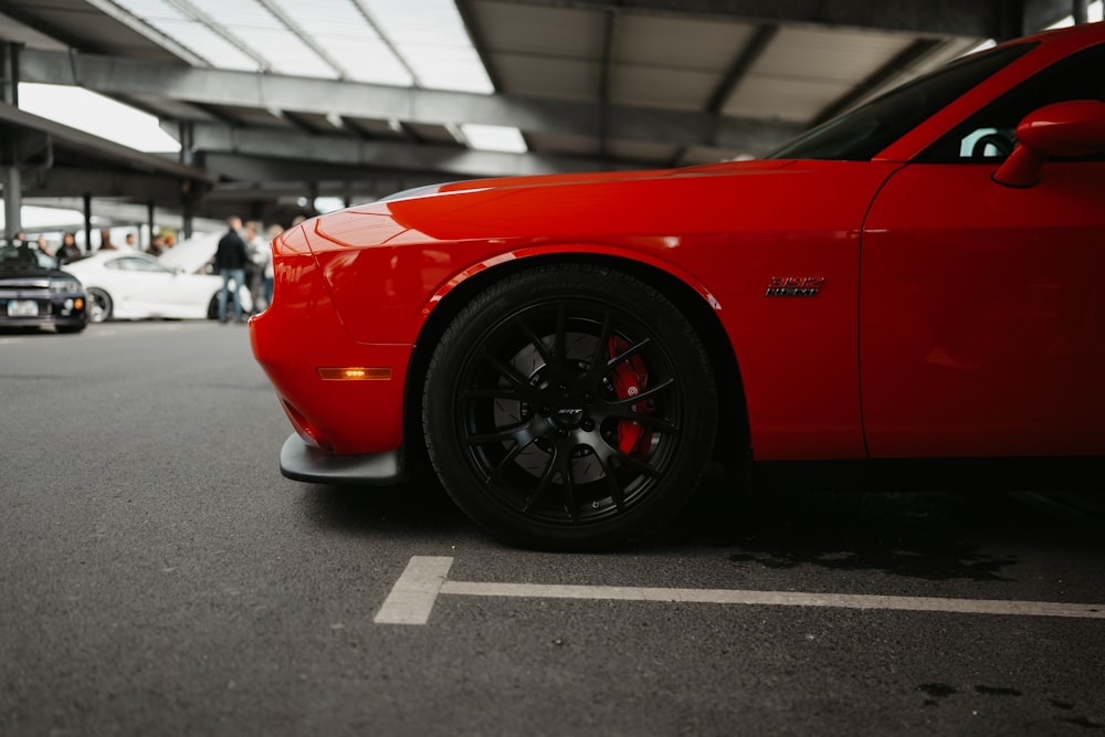 a red sports car parked in a parking lot