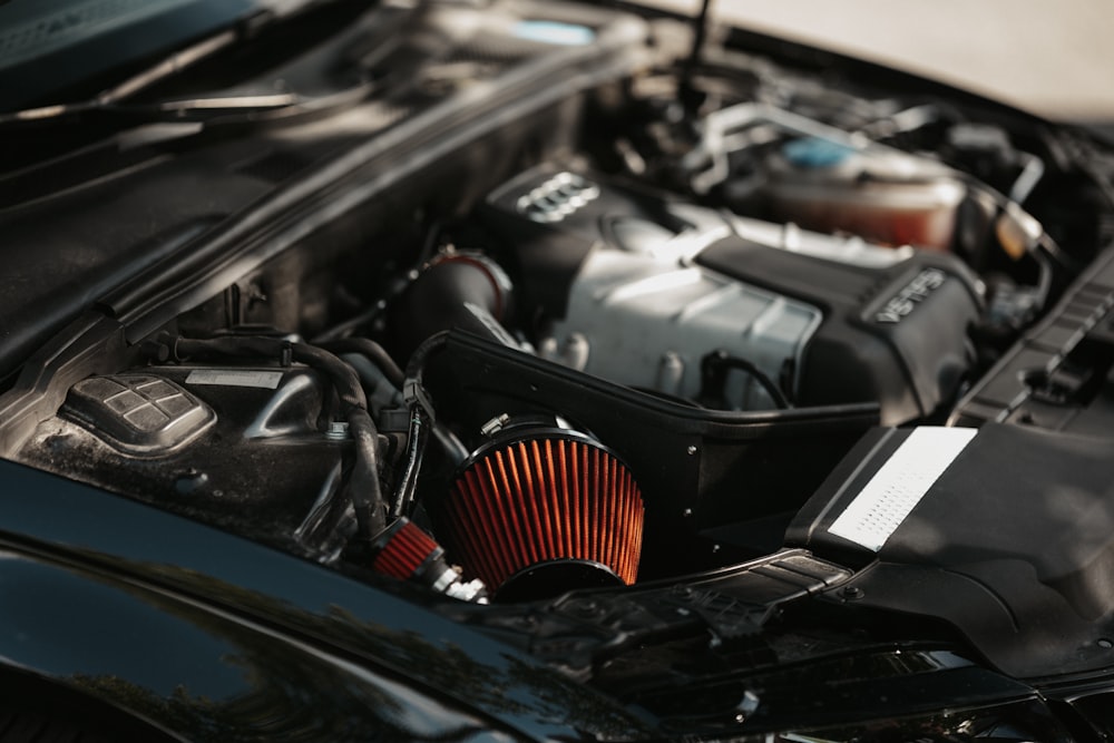 a close up of a car engine with its hood open