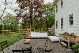 a patio with a table and chairs and a couch