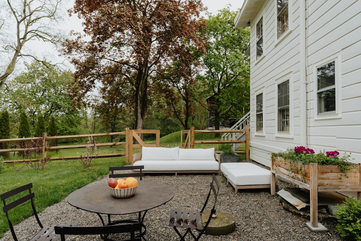 Residential outdoor living space with stone patio and garden