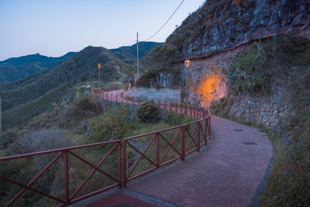 a path leading up to a stone building on a hill