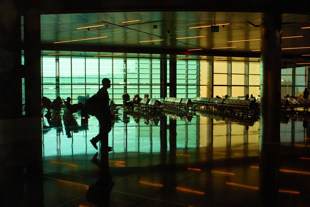 a man is walking through an airport terminal