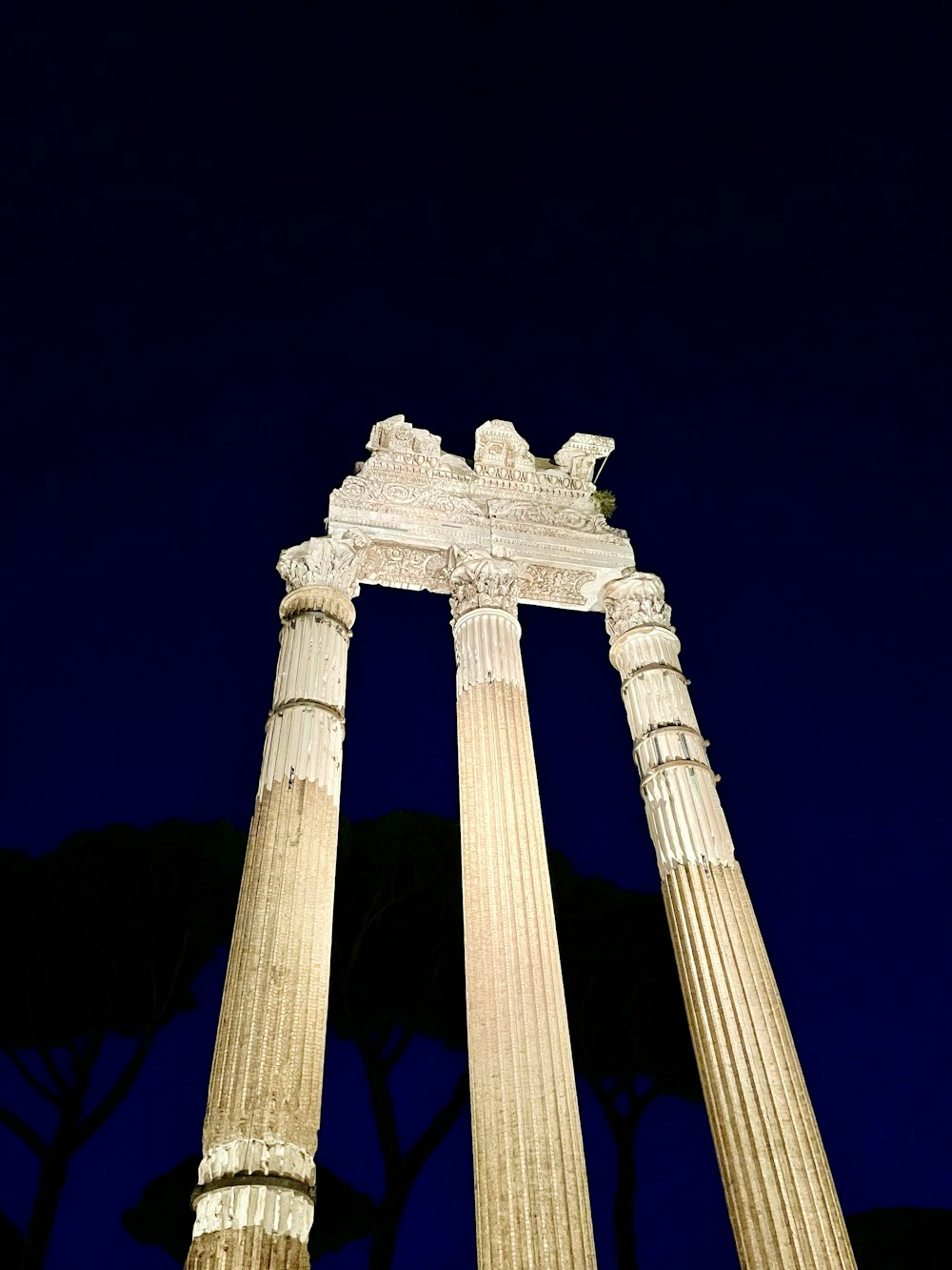 a couple of tall white pillars sitting next to each other