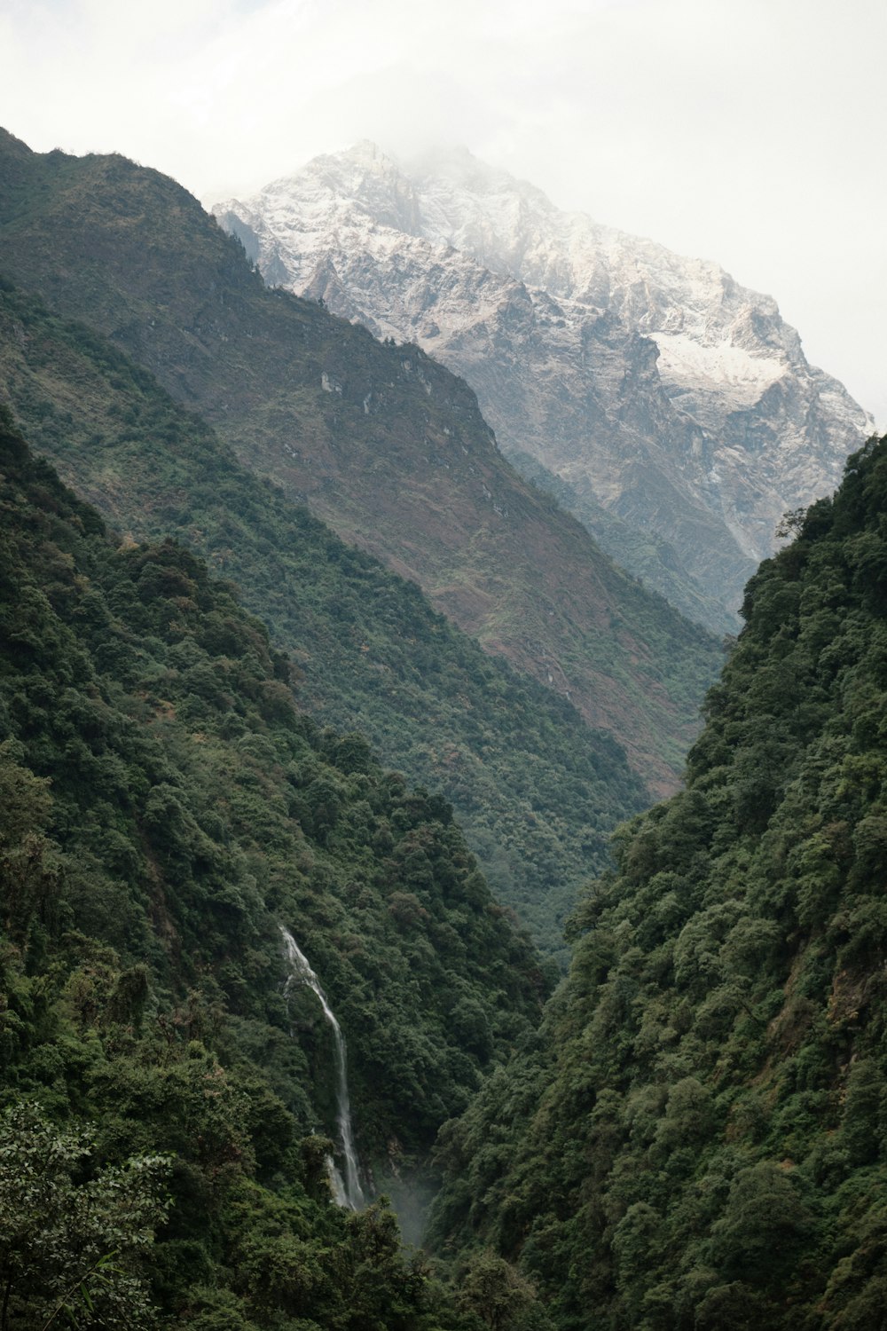 a mountain with a waterfall in the middle of it