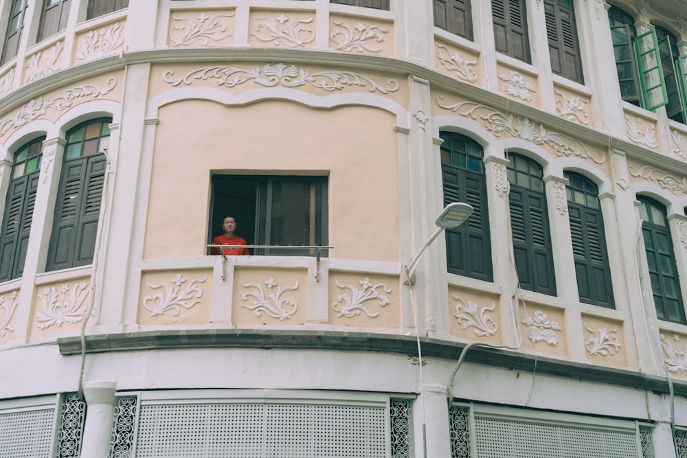 a person standing in a window of a building