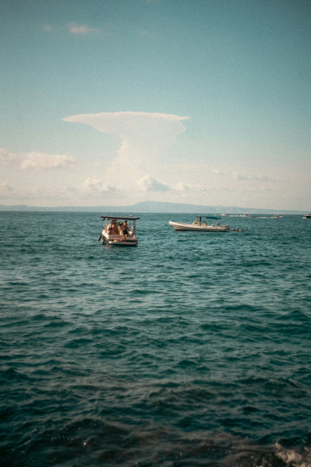 a small boat floating on top of a large body of water