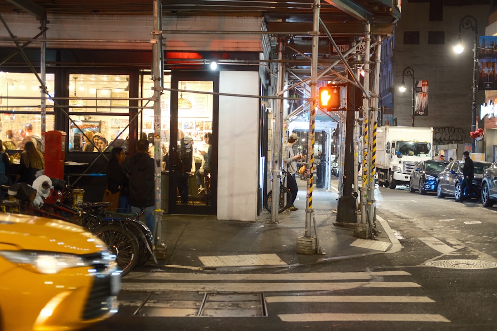 a busy city street at night with cars and scaffolding