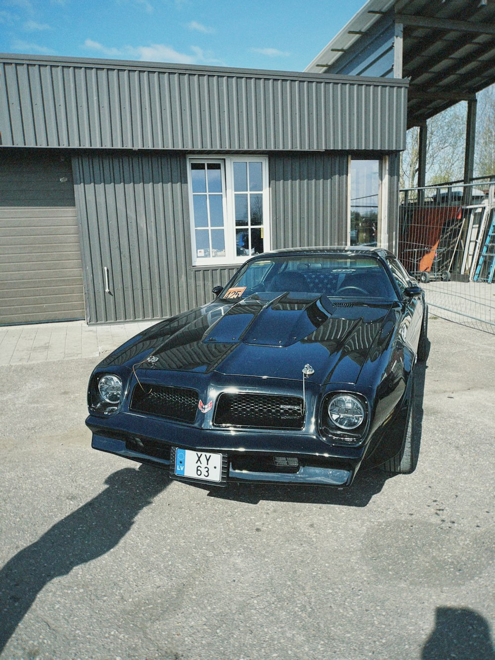 a black car parked in front of a building