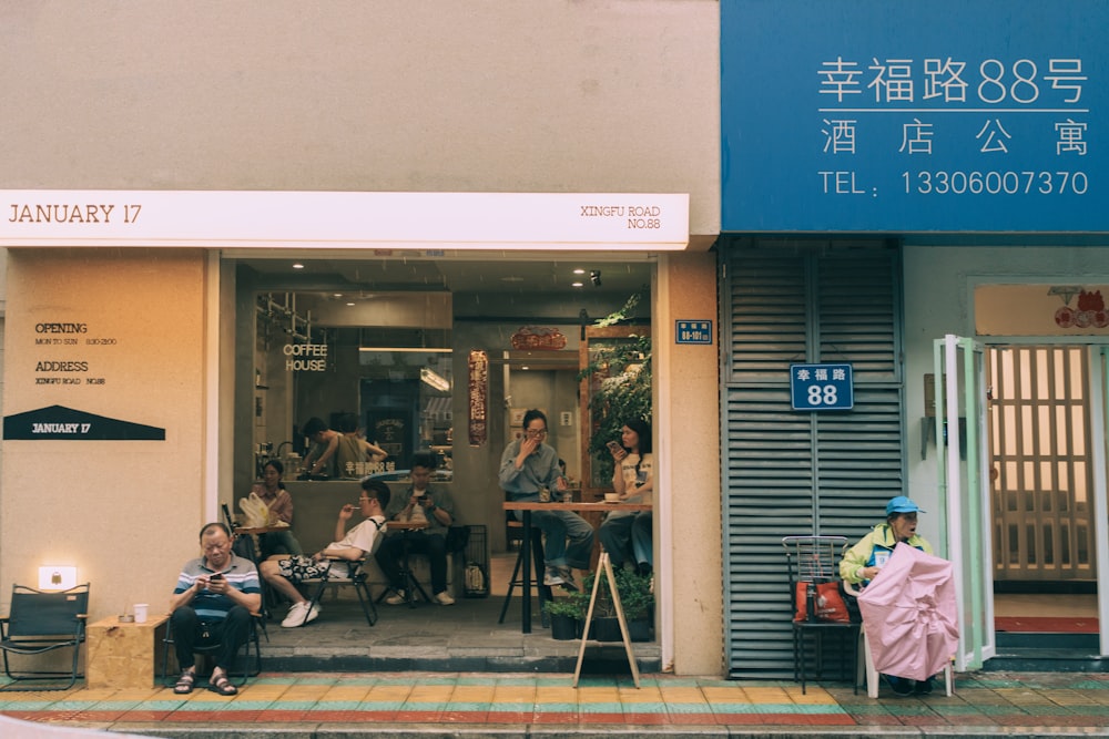a group of people sitting outside of a building