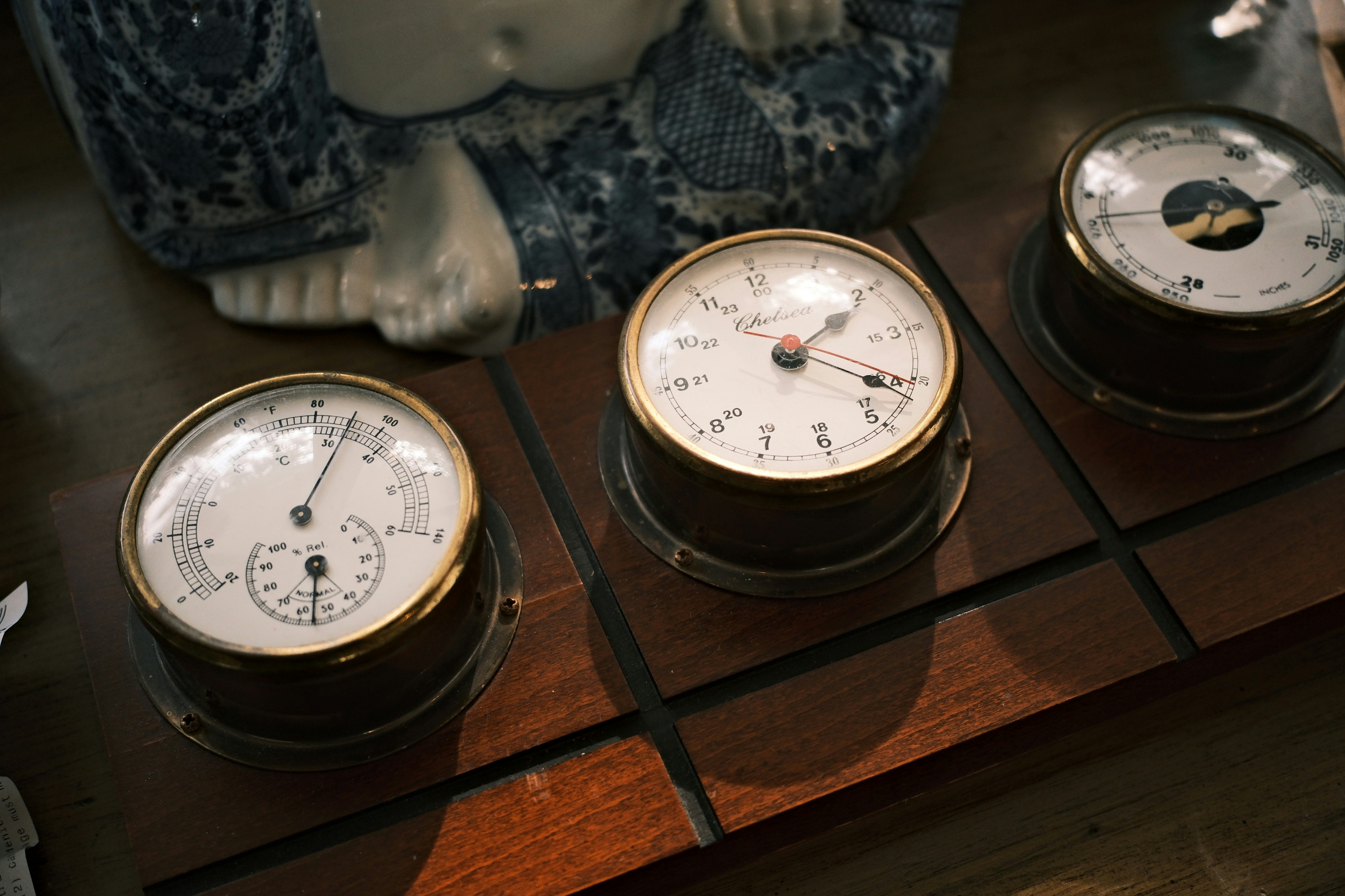 three clocks sitting on top of a wooden table