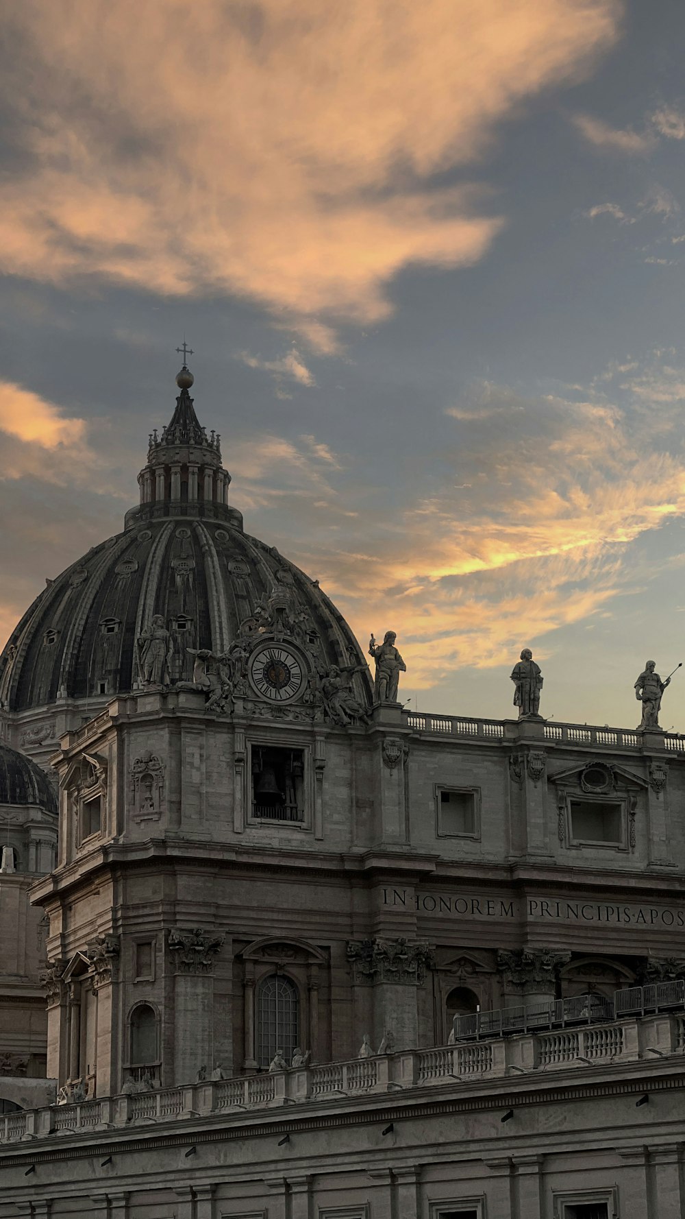 a building with a dome and statues on top