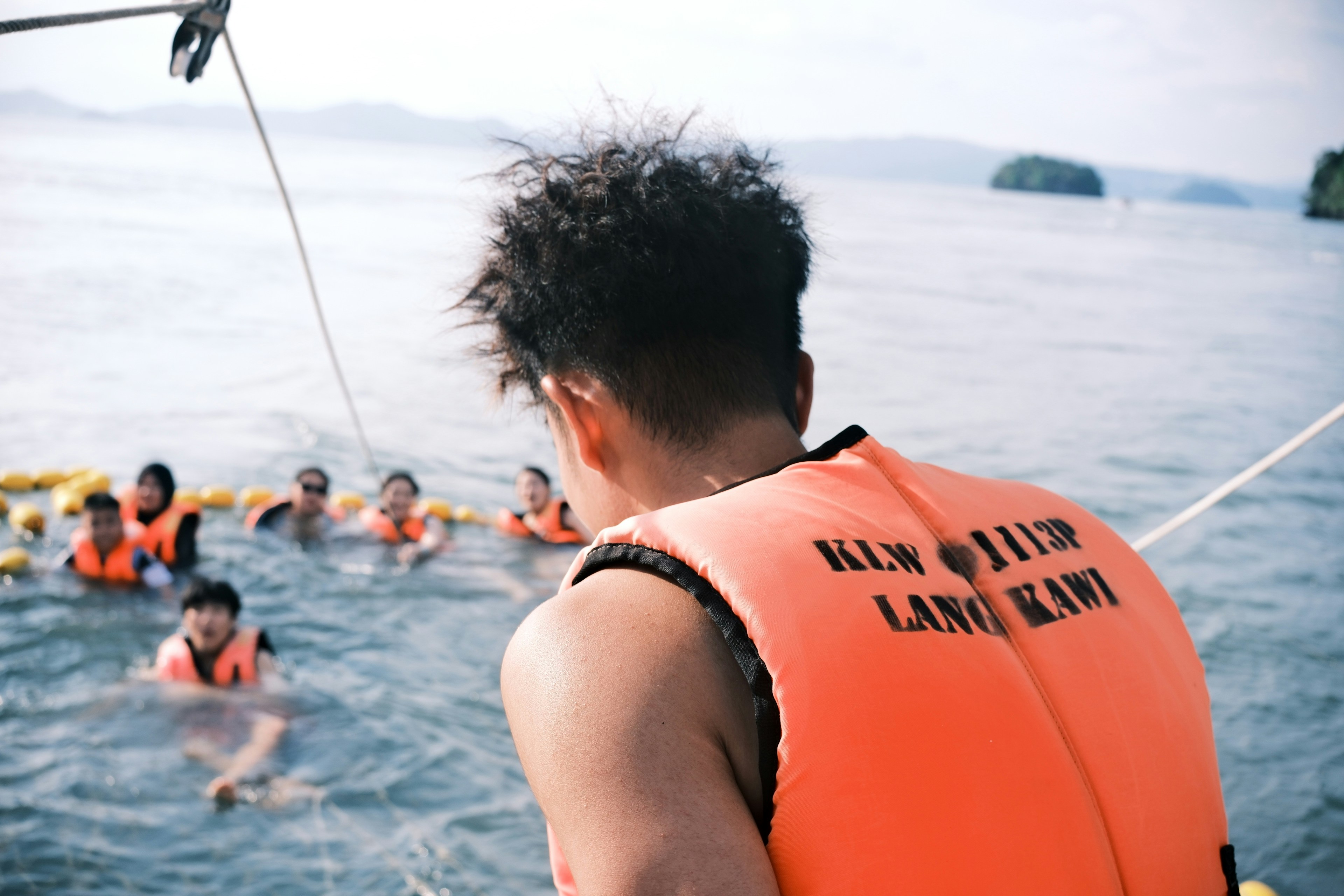 Orange personal flotation device vest on white background