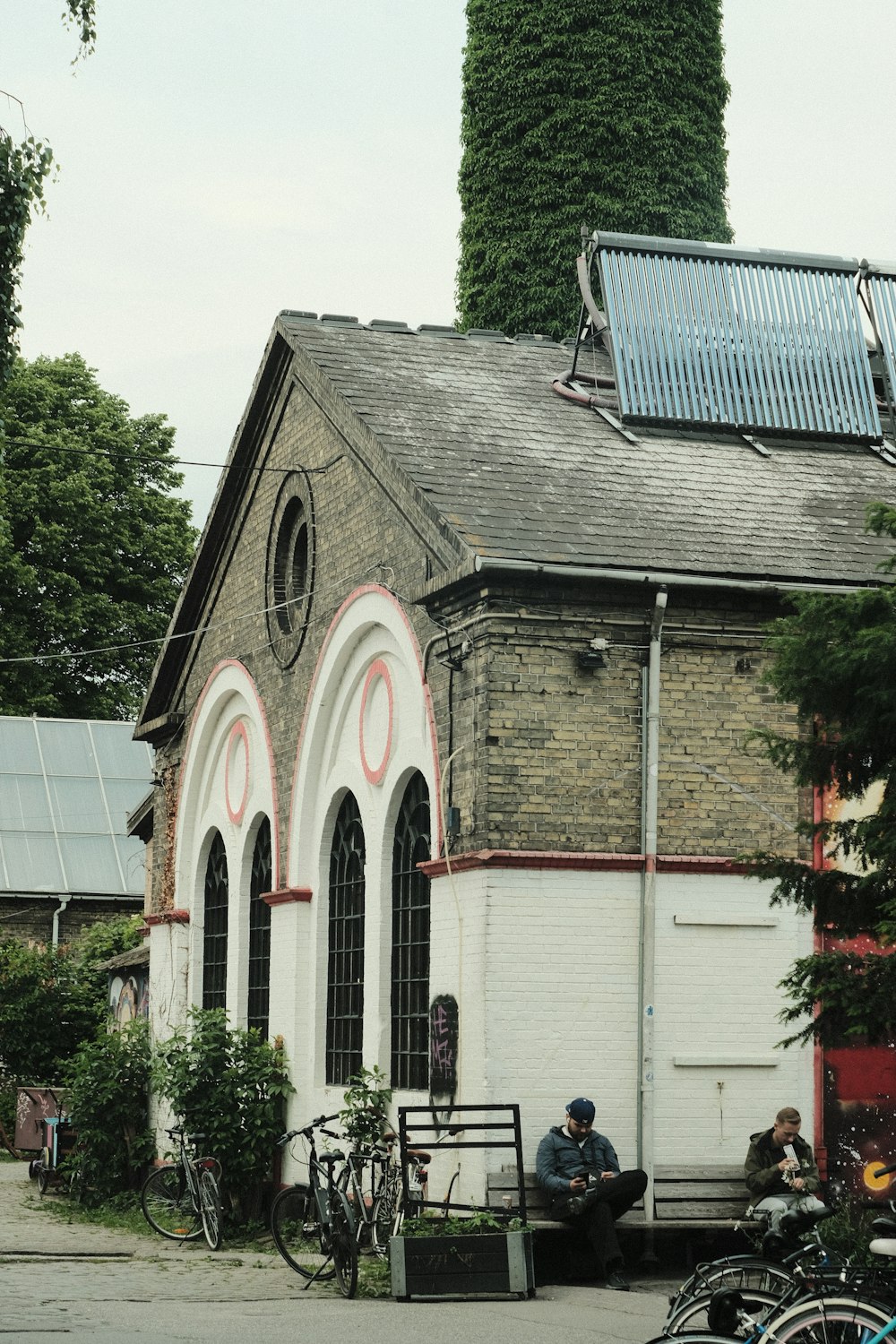 a man sitting on a bench in front of a church