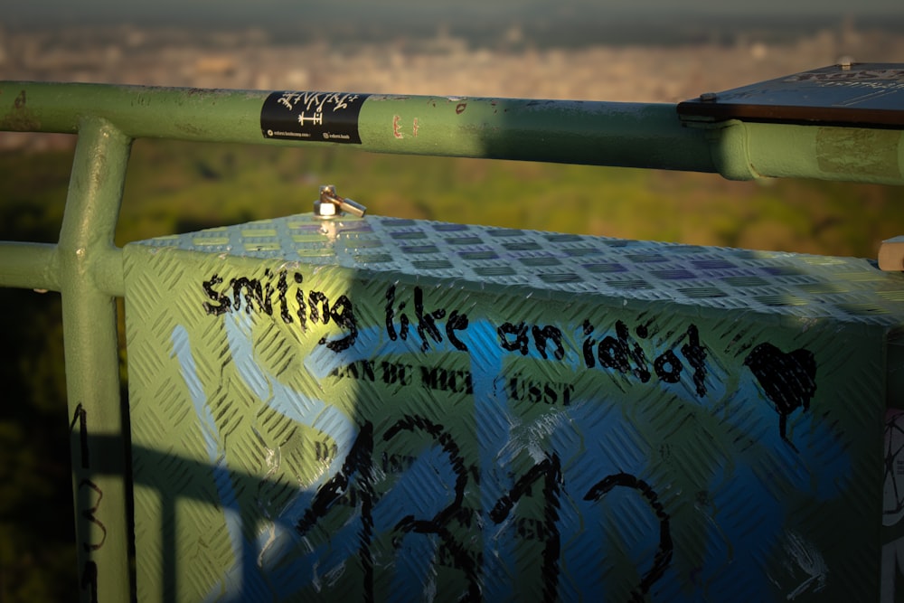 a box with writing on it sitting on a rail