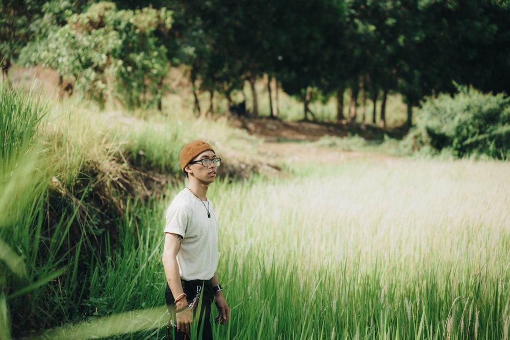 a man standing in a field of tall grass