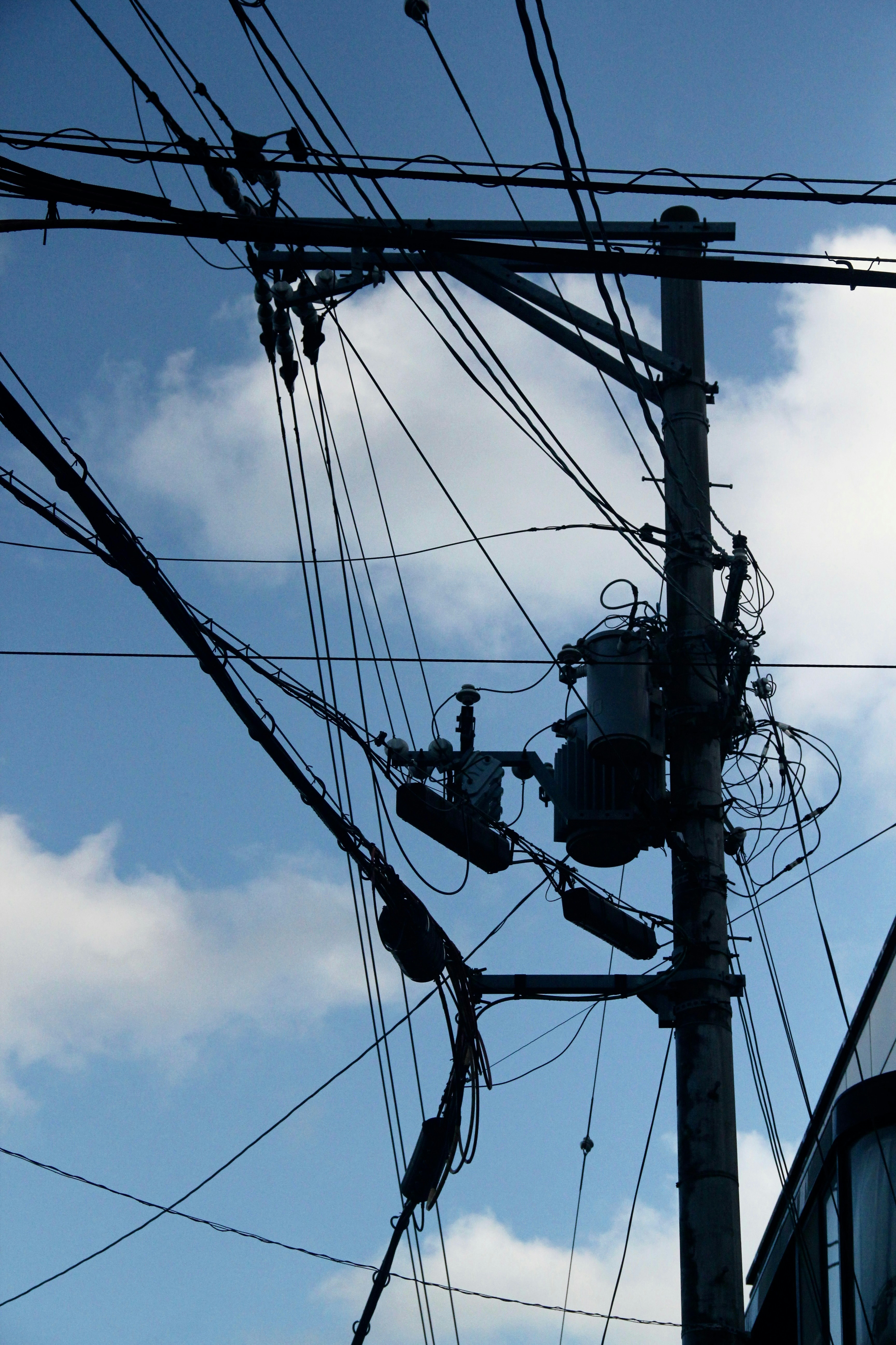 power lines and wires against a blue sky