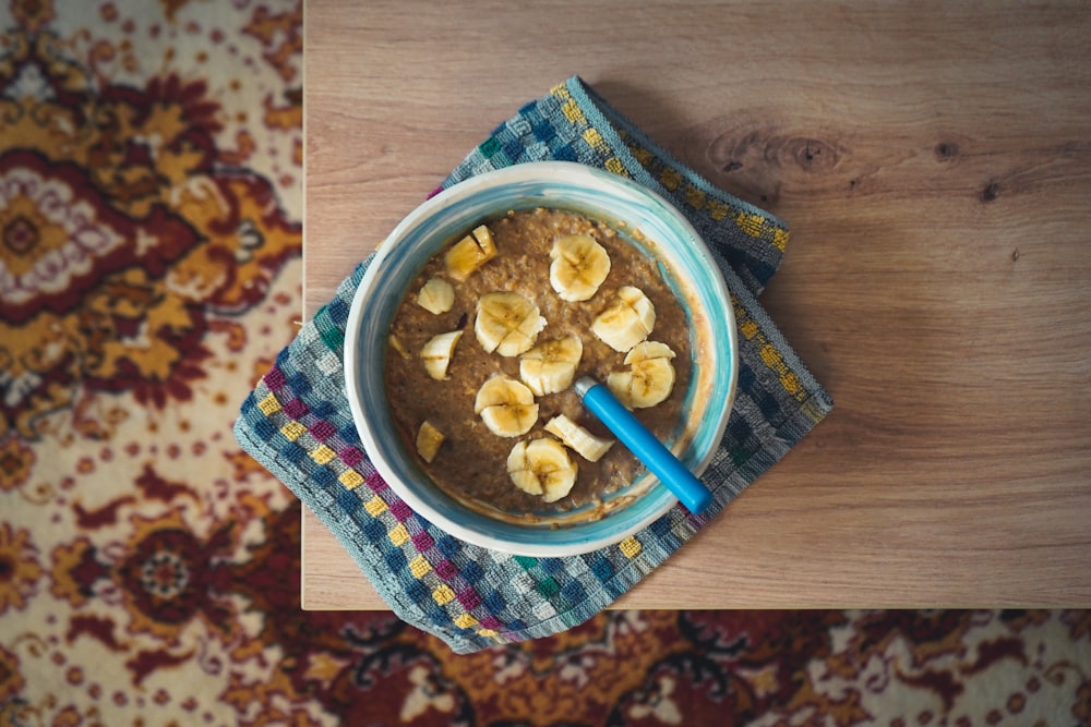 a bowl of oatmeal with banana slices on top