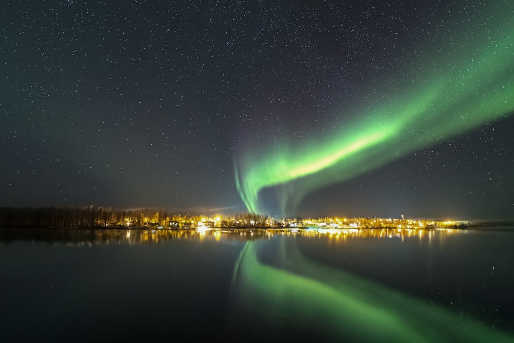 the aurora bore is reflected in the water at night