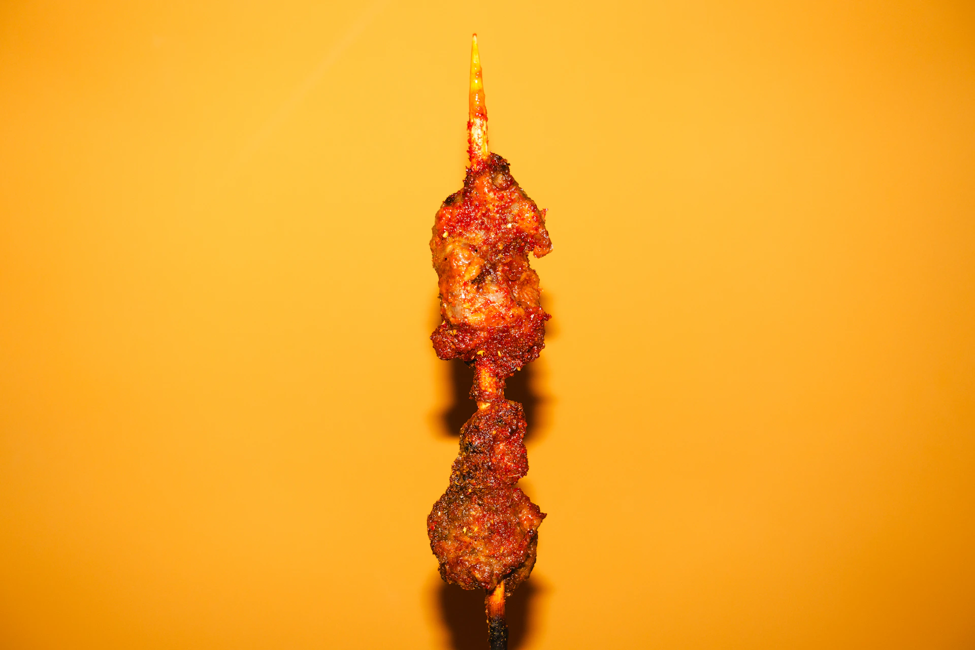 a close up of a piece of food on a stick